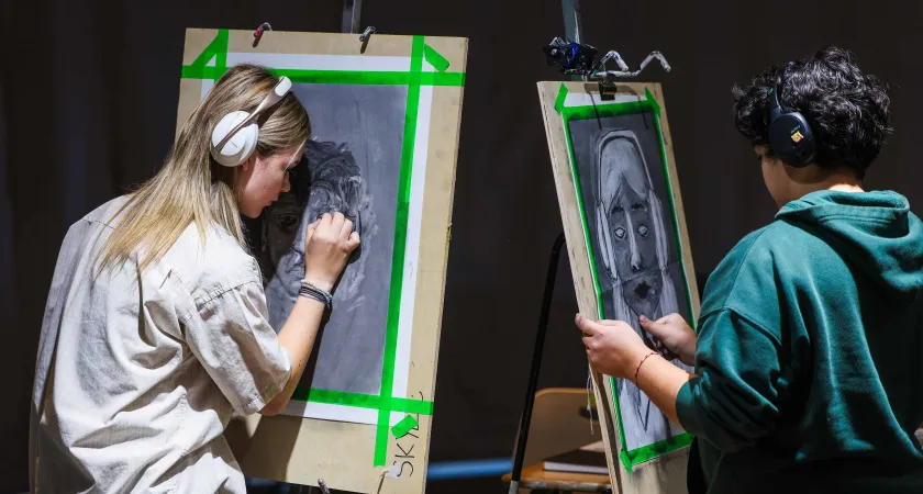Two Visual Art students drawing faces