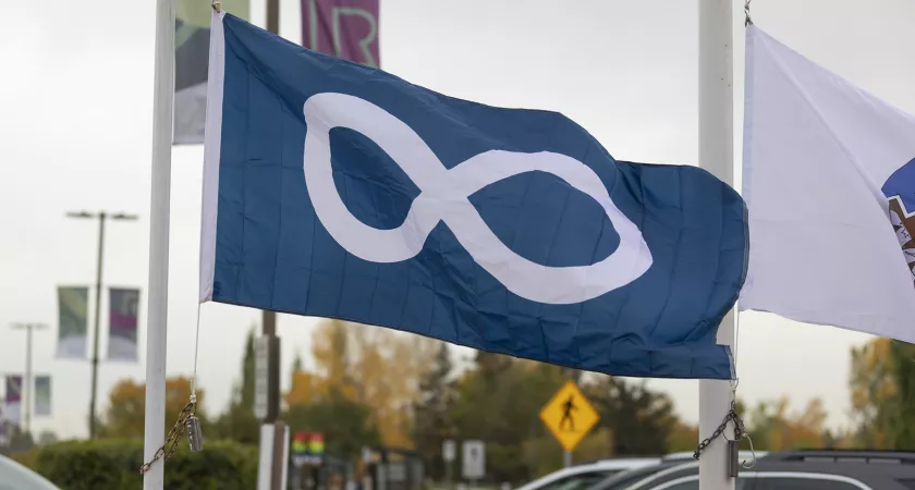 A blue Metis flag blowing in the wind outside RDP