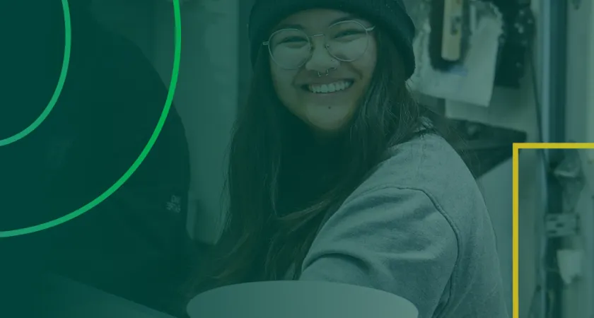 A smiling female student in an art studio with some transparent green graphics overlayed