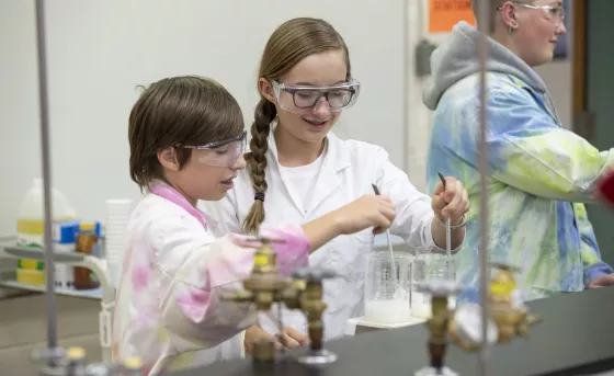 Two children doing experiment in science lab