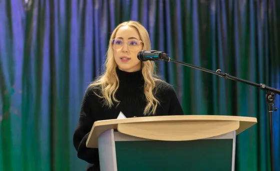 Student presenting at podium
