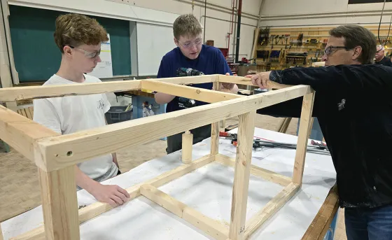 Students are assisted by an RDP instructor as they build a potato planter