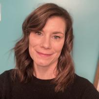 Smiling headshot of Dani Williams against a teal wall