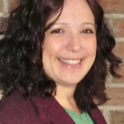 A smiling headshot of Heather Marcovitch in front of a brick wall