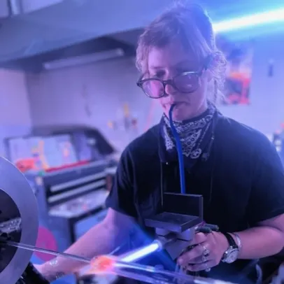 Selene Huff in a workshop using some large scale equipment