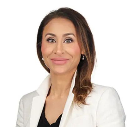 Smiling headshot of Ms. Melina Dharma-Wardene on a white background