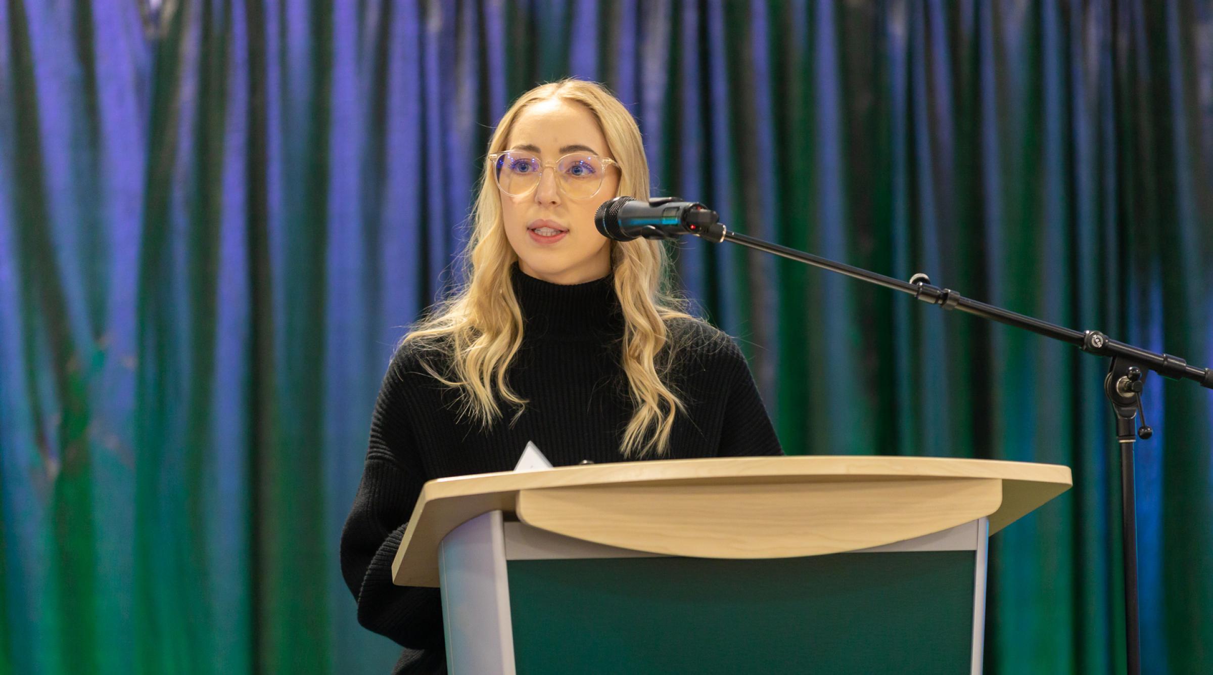 Student presenting at podium