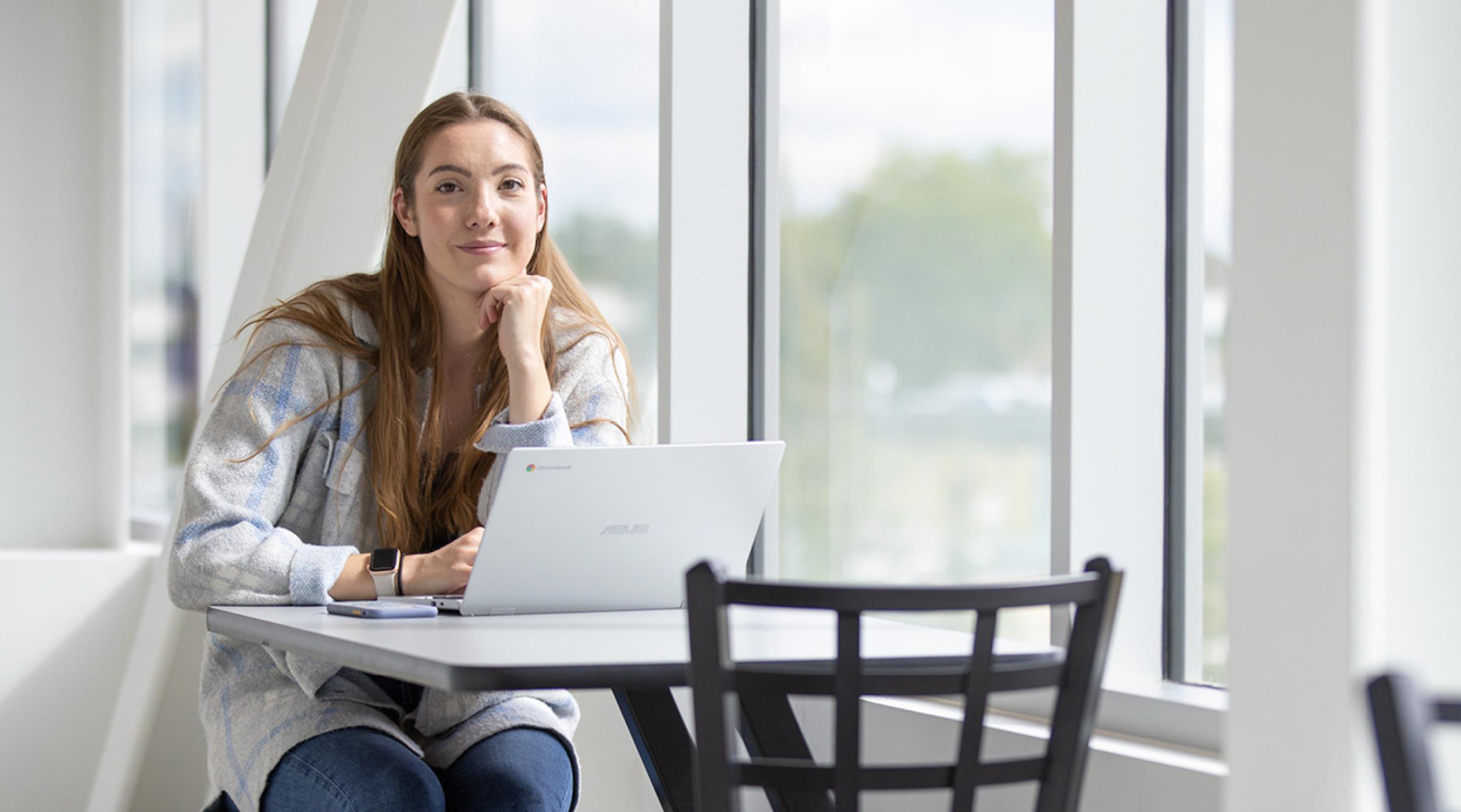 Girl at table on laptop