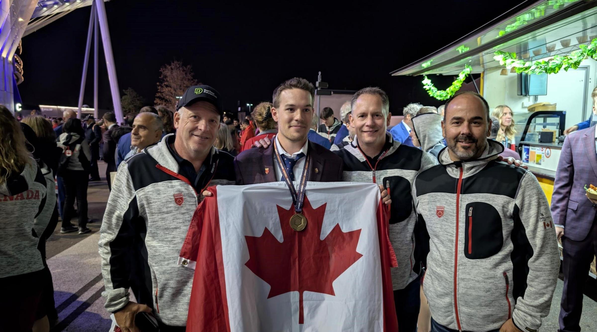 Ben Rainforth with Coach and RDP faculty, Lee Yasinski holding bronze medal and Canadian flag at WorldSkills competition