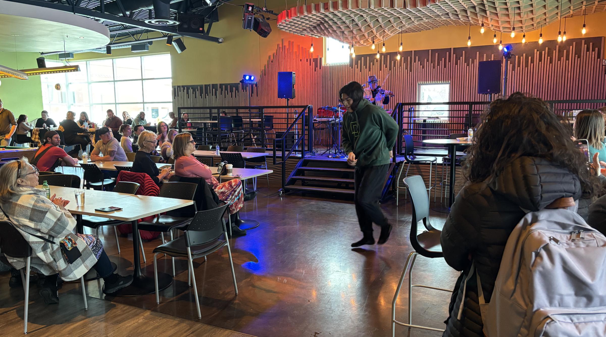 A man performs in front of a crowd in the FarSide at RDP to celebrate the new Indigenous Centre