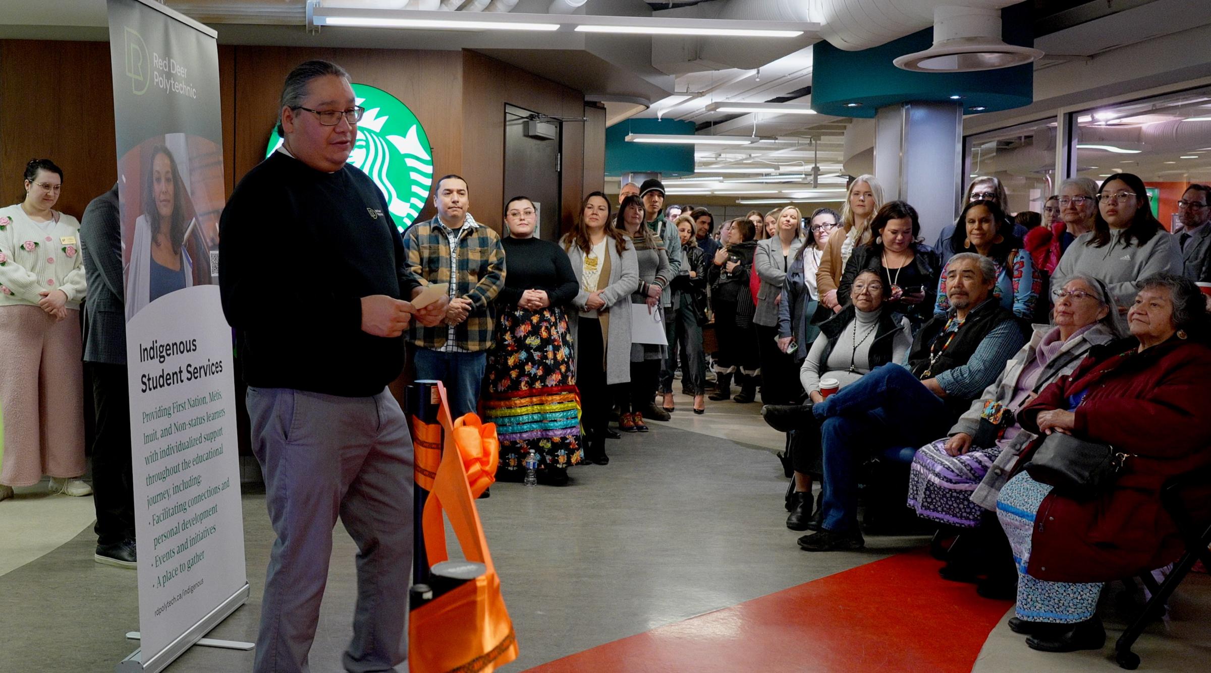 Lloyd Desjarlais addresses a large crowd at the Pónokaisissáhta Ribbon Cutting Ceremony