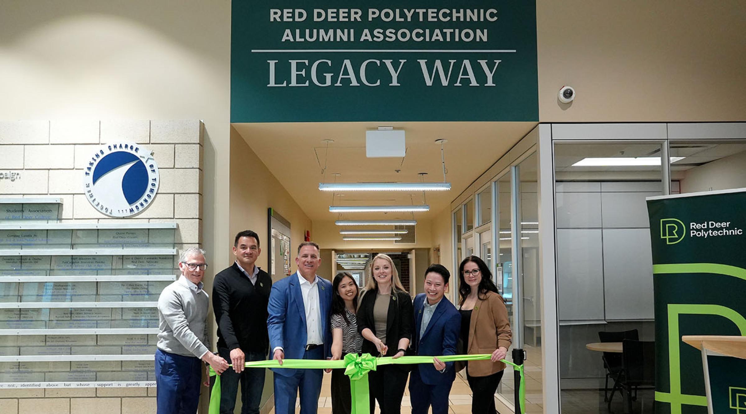 Representatives from RDP and the Alumni Association cut a ribbon to celebrate the opening of Red Deer Polytechnic Alumni Legacy Way on main campus
