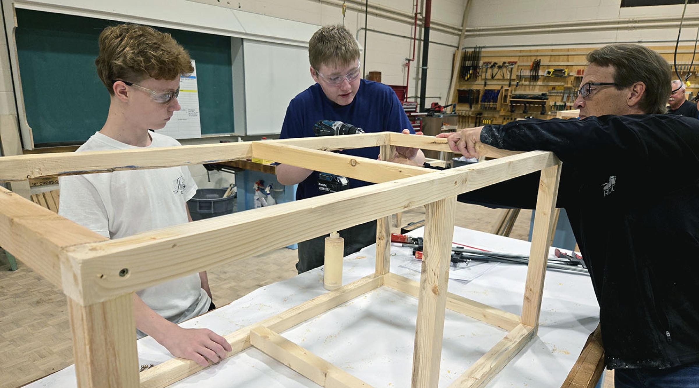 Students are assisted by an RDP instructor as they build a potato planter