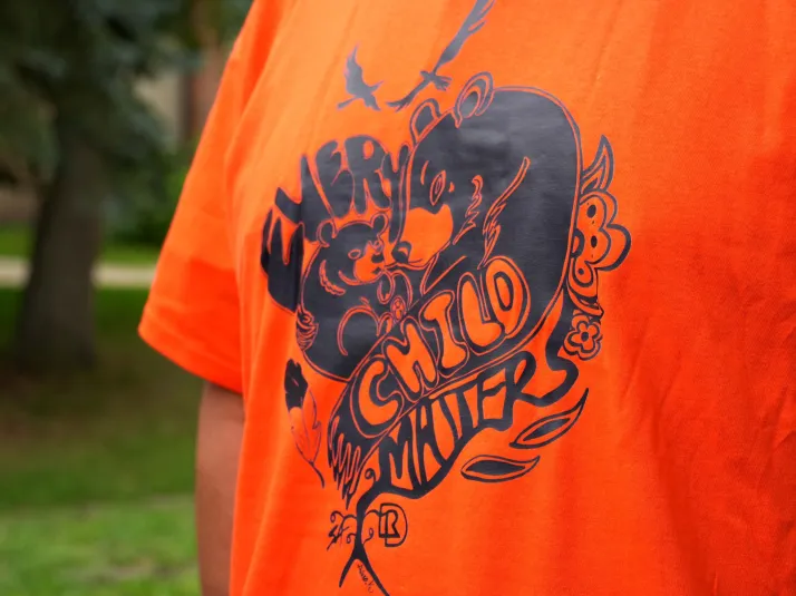 2025's Orange Shirt Day Contest's winning shirt with "Every Child Matters" in the shape of a heart made up of Indigenous iconology