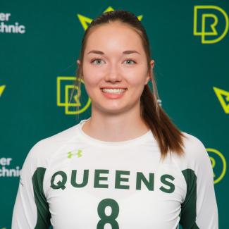 Lauren Junck wears Queens #8 jersey in front of an RDP backdrop