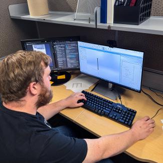 Evan works on a computer designing the modifications.