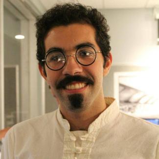 Alireza, in a white button up shirt and glasses.