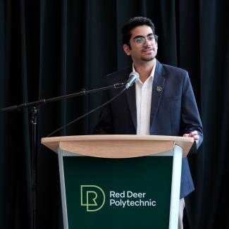 Akshun Chauhan (Computer Programming Diploma alum and intern at Energy Innovation Centre) addresses the crowd