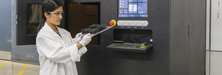 Research technician using 3d printer