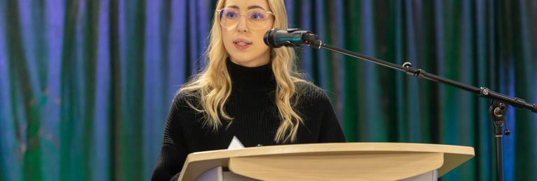 Student presenting at podium