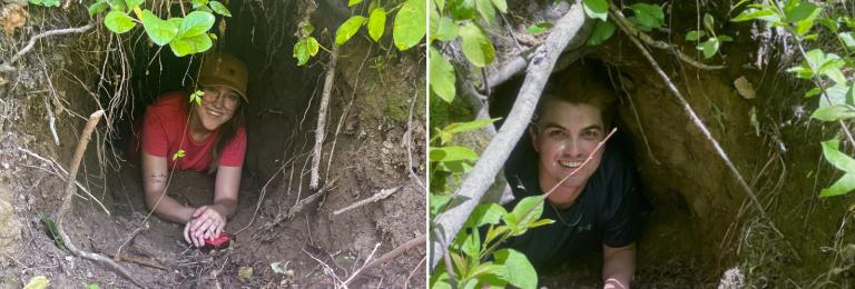 Researchers Meggy & Kyle smile while laying in the entrance of a bear's den.