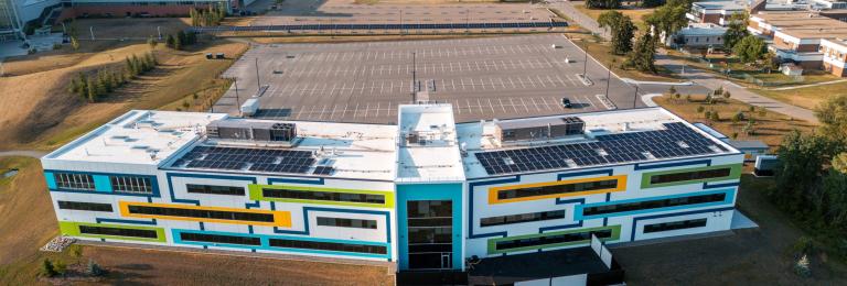 an aerial shot looking down at the multi-coloured CACAC building called the Sheldon Kennedy Centre of Excellence