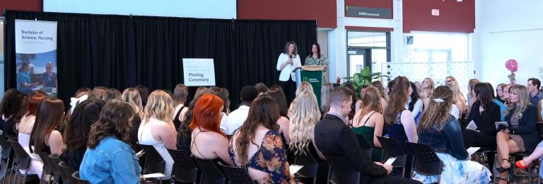 RDP Nursing faculty address a group of graduating nurses and their supporters