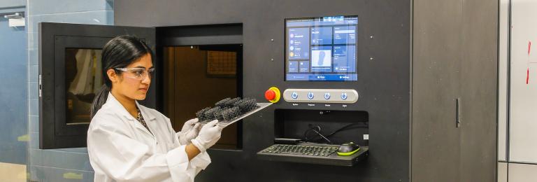 Research technician using 3d printer.