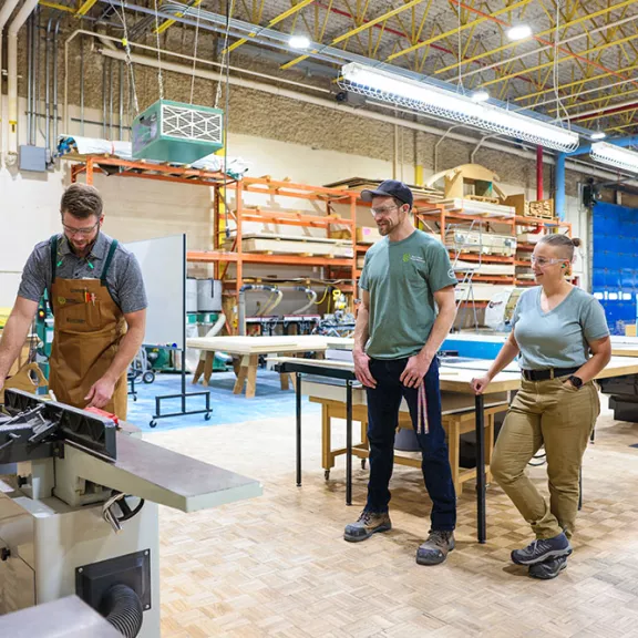 Carpentry student using saw