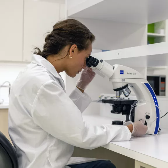 Female Student at Microscope