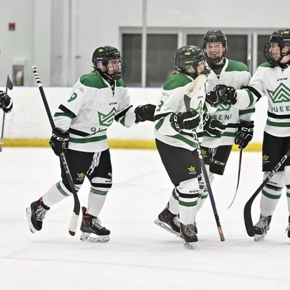 Queens Hockey players celebrating a goal