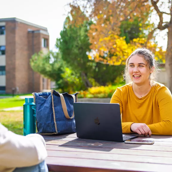 Female student sitting outside