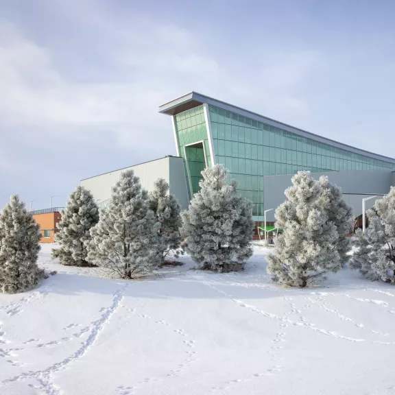 Beautiful field of snow with footprints headed towards the Gary W. Harris Canada Games Centre