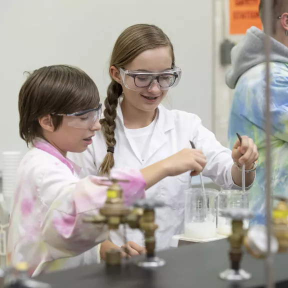 Two children doing experiment in science lab