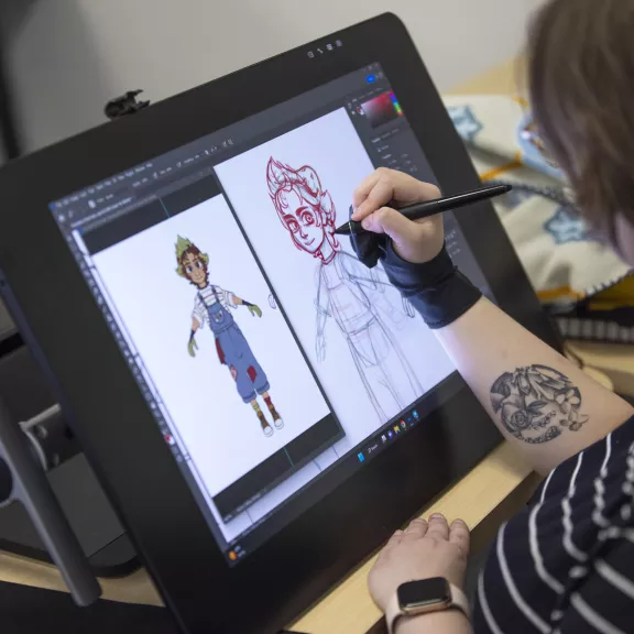 Animation student drawing on computer screen