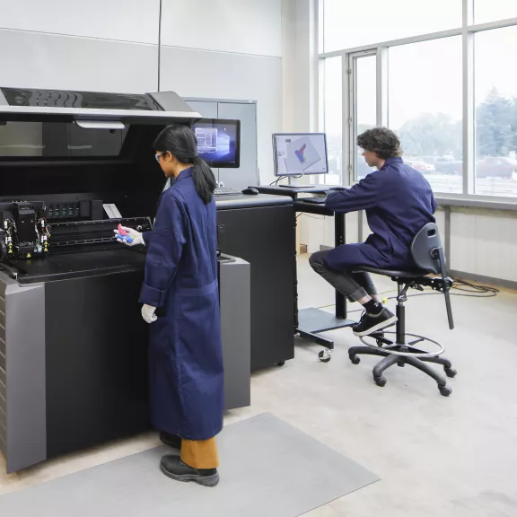 Research technician using 3d printer 