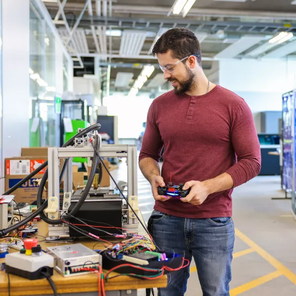 A technician working with technical components in a lab.