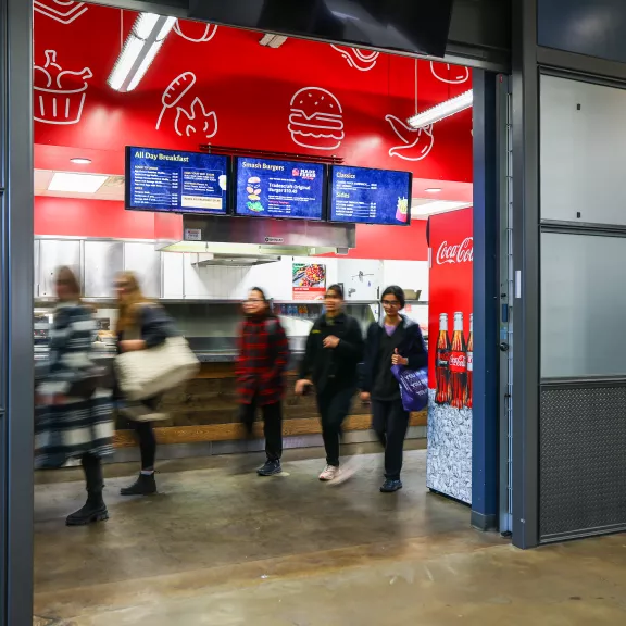 People walking through The Patch cafeteria style restaurant.