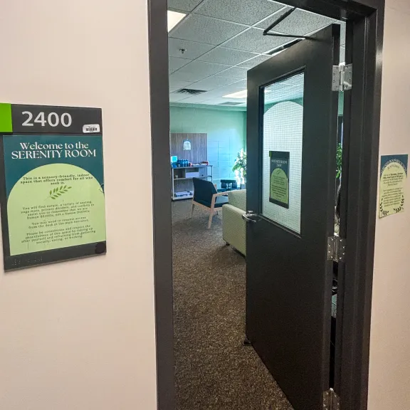 A view through the door of the serenity room showing seating with bright natural light.