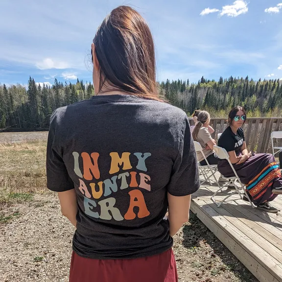 A student participates in RDP's Auntie's in Training camp, showcasing the camp's t-shirt