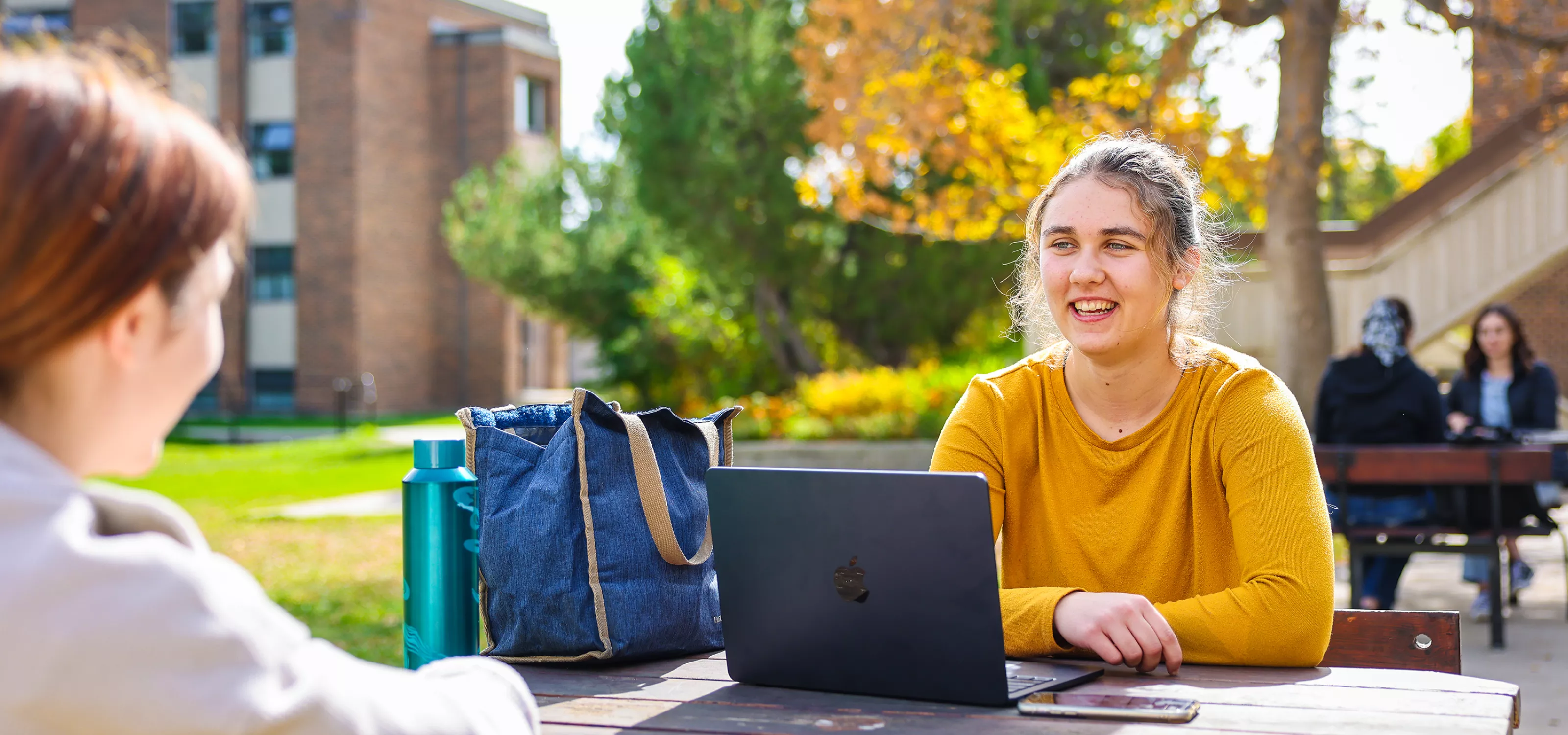 Female student sitting outside