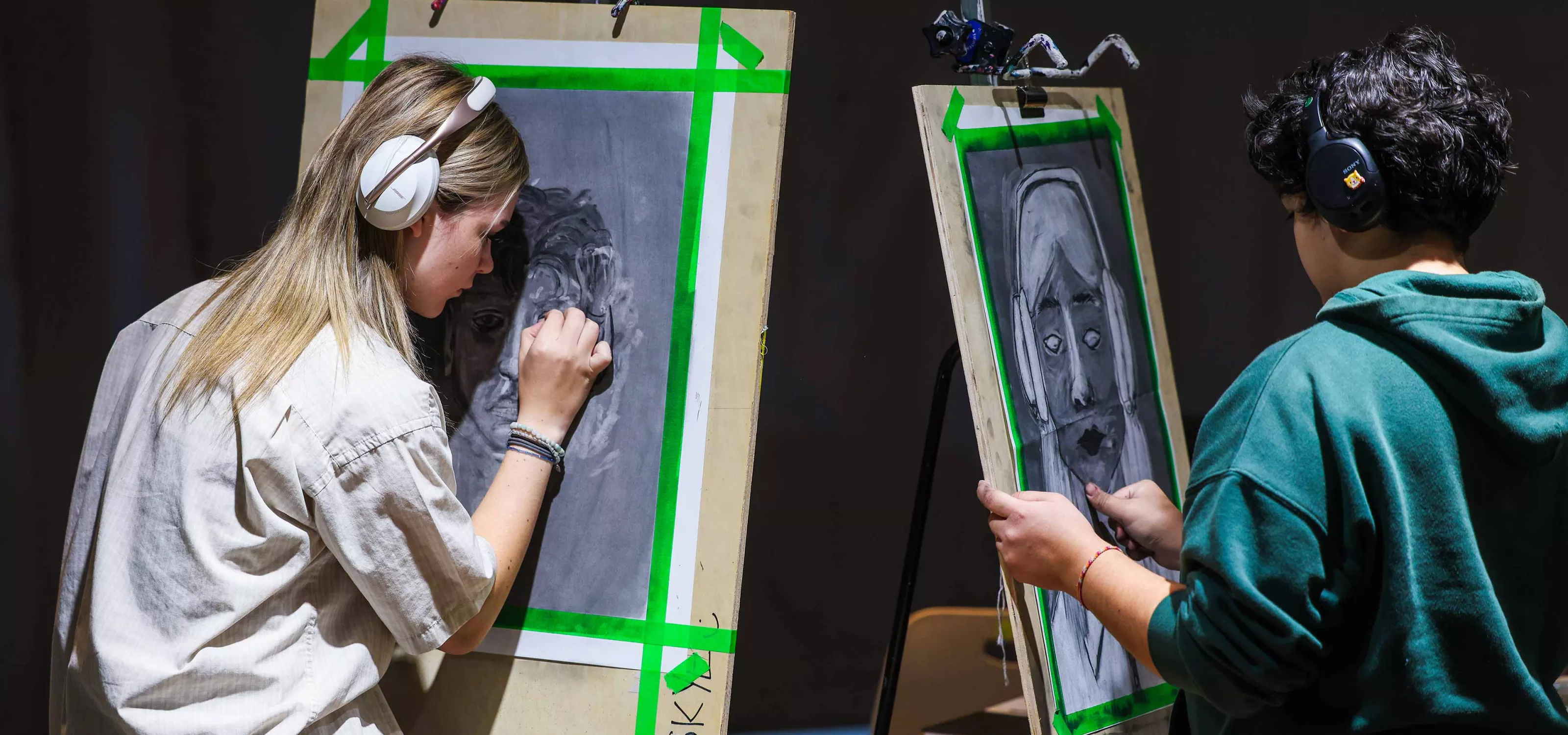 Two Visual Art students drawing faces