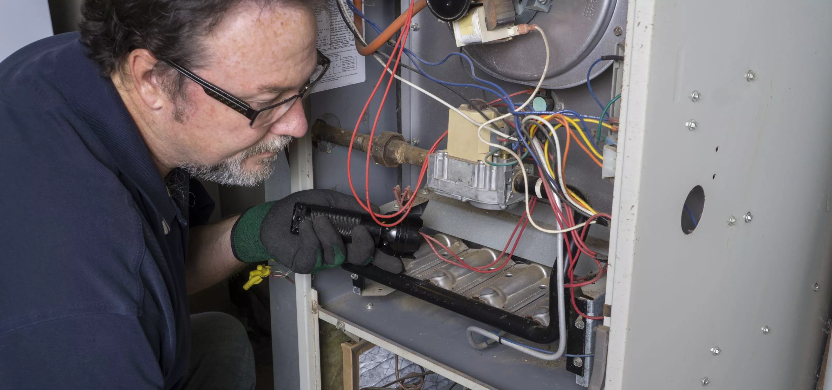 Technician fixing a furnace.