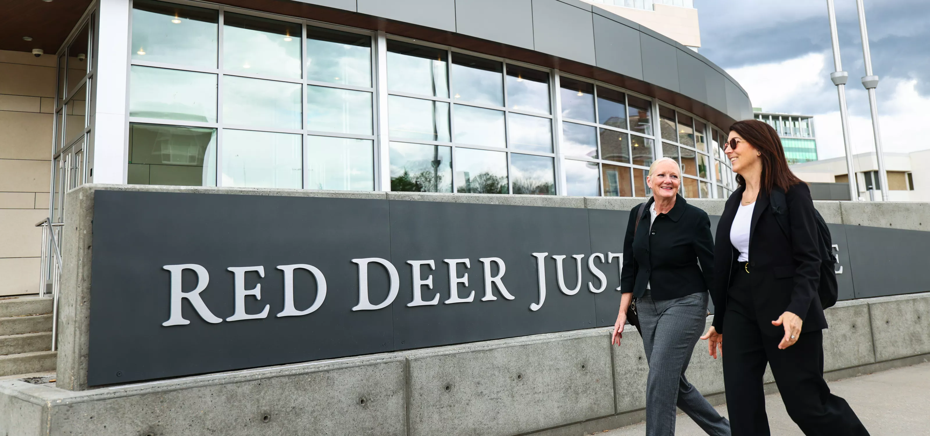 Two women walking past the Red Deer Justice Centre Court of King's Bench 